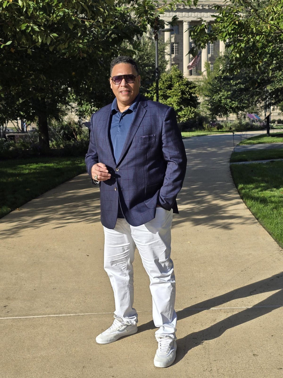 Nick in a navy blazer on a tree-lined walk in Washington, D.C.