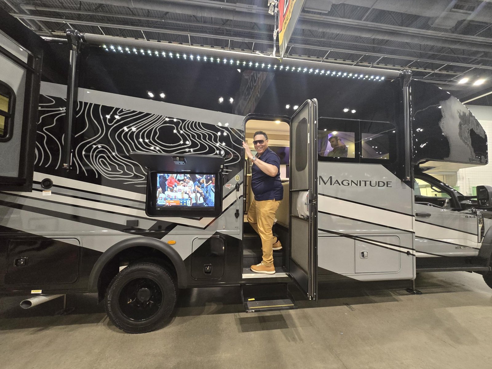Nick stepping into a luxury RV at a showroom